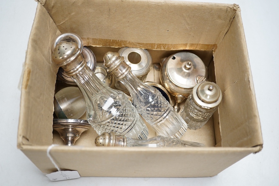 A modern pair of silver mounted glass match strikes, a pair of silver dwarf candlesticks and sundry silver including condiments and cruet bottles. Condition - poor to fair